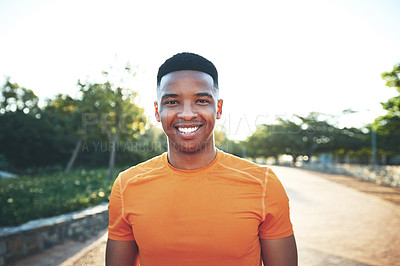 Buy stock photo Cropped shot of a young man smiling while our for a workout