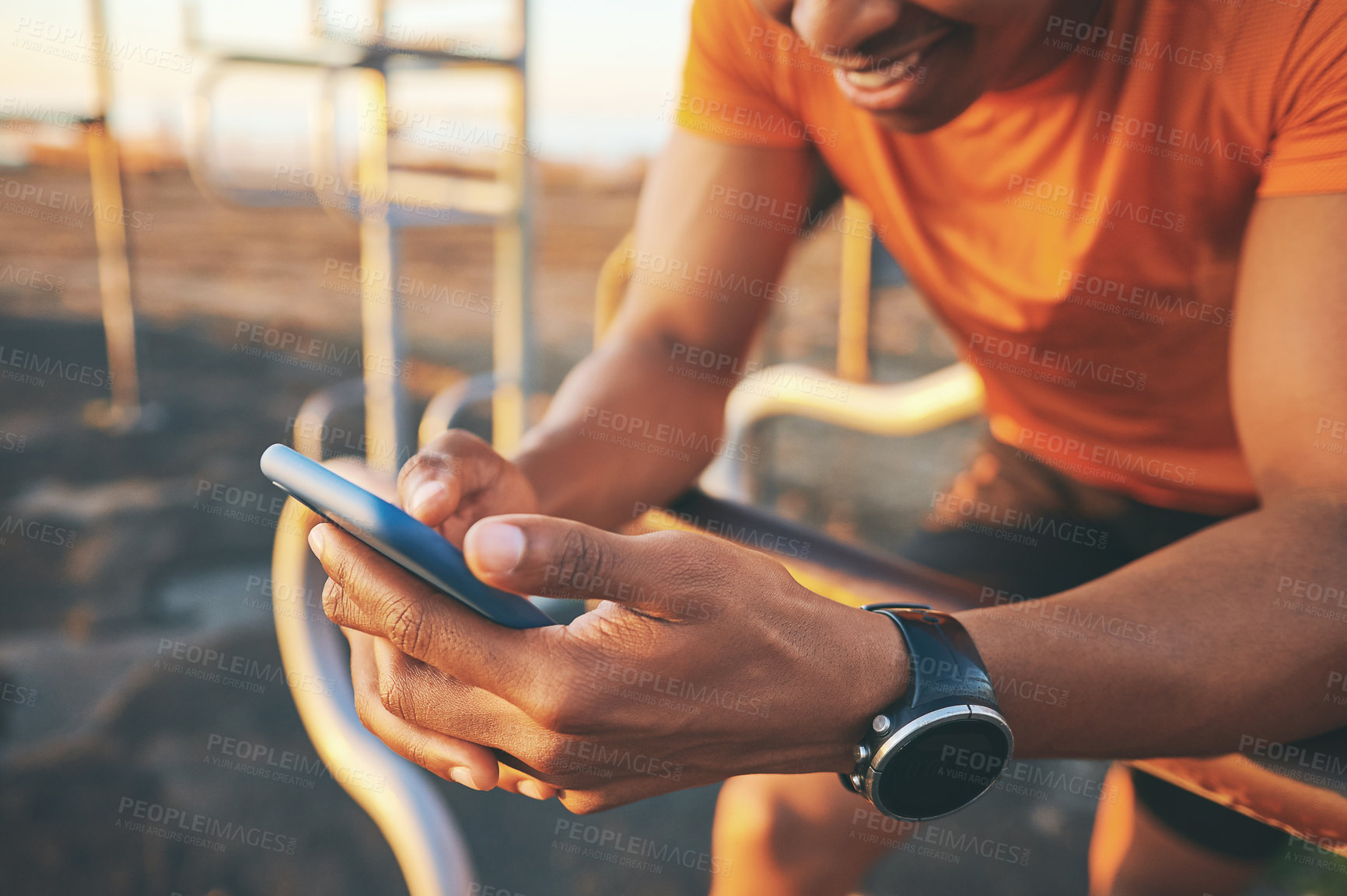 Buy stock photo Shot of a man checking his cellphone while out for a workout