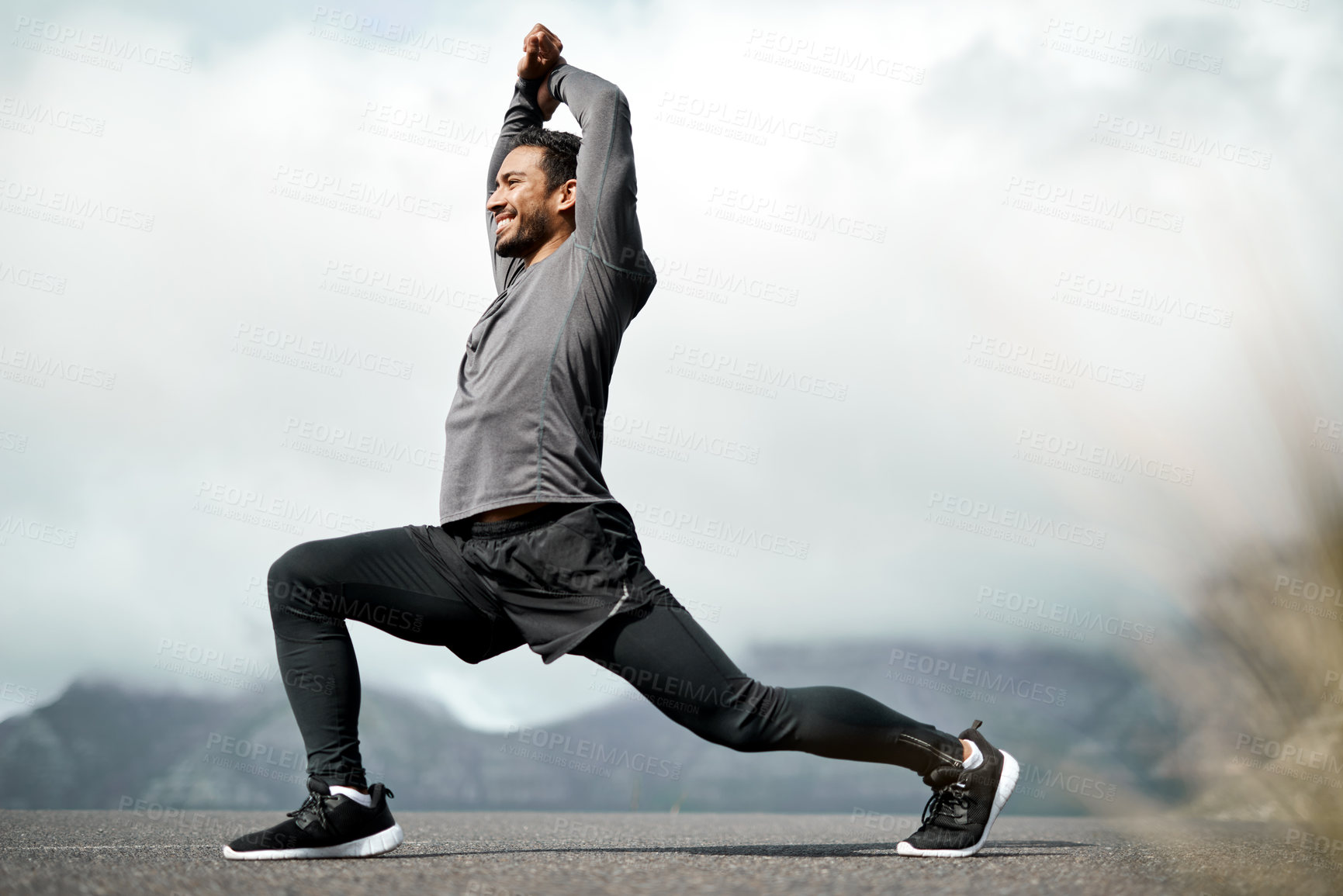 Buy stock photo Full length shot of a handsome young man stretching before exercising outdoors alone