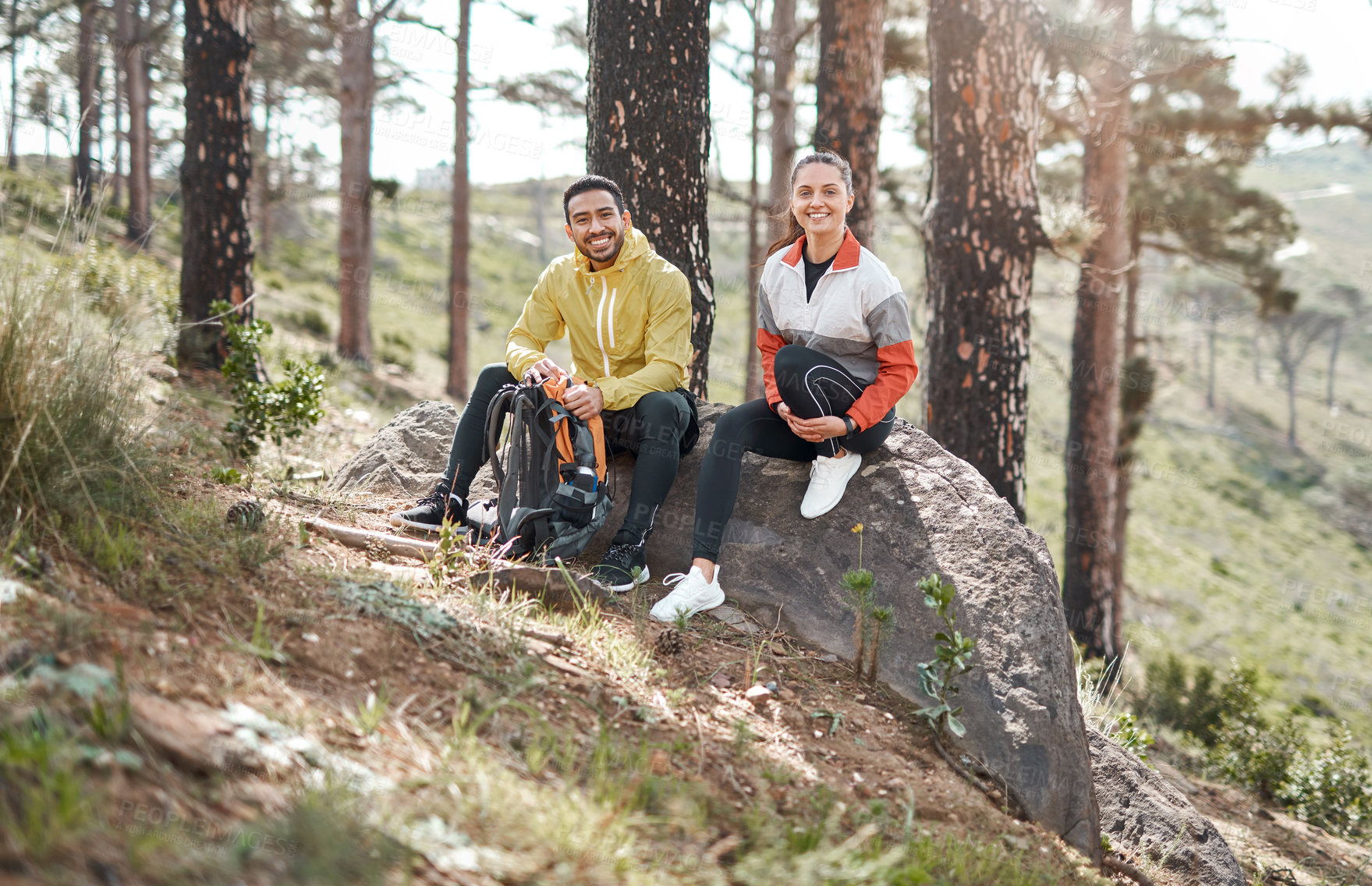 Buy stock photo Full length portrait of two young athletes sitting together after a morning run through the woods