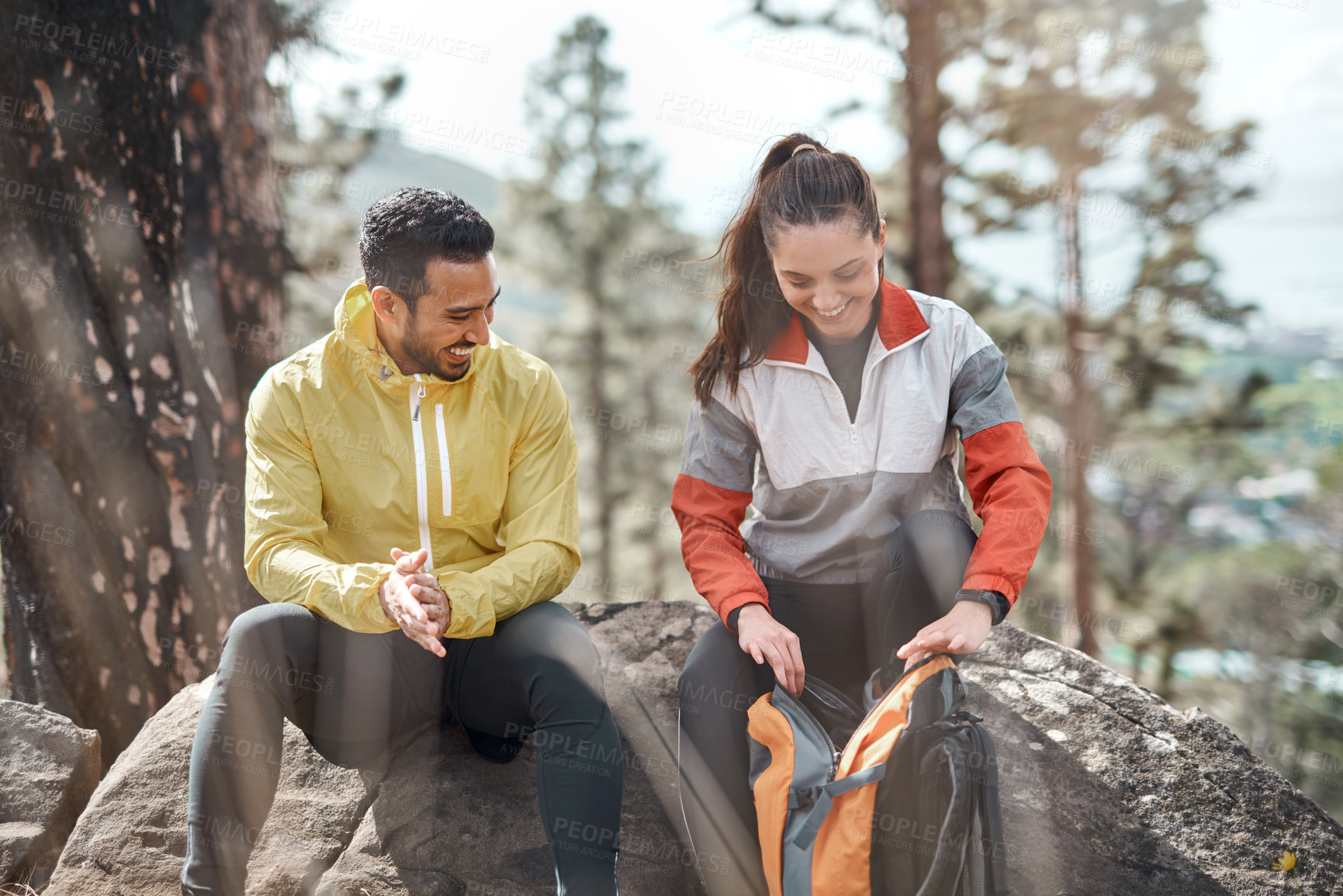 Buy stock photo Cropped shot of two young athletes sitting together after a morning run through the woods