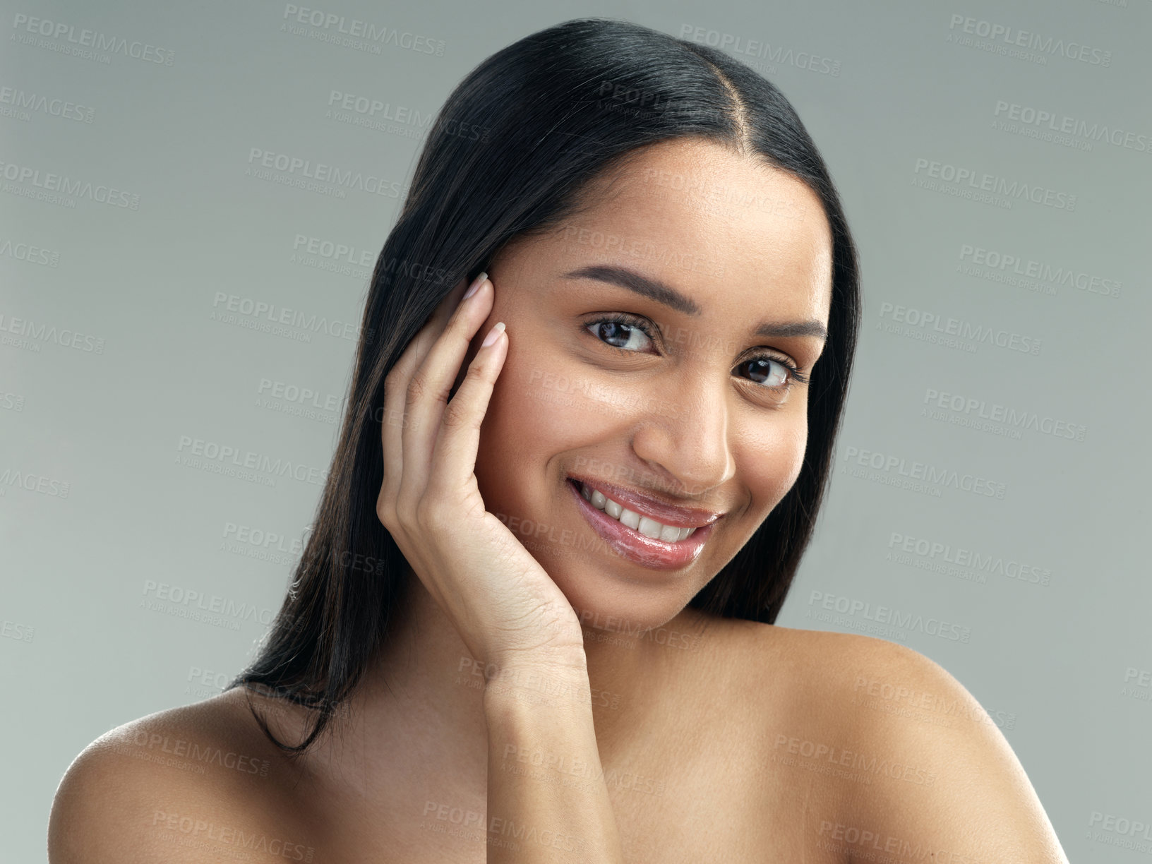 Buy stock photo Cropped shot of a beautiful young woman with flawless skin posing against a grey background