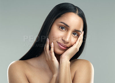 Buy stock photo Cropped shot of a beautiful young woman with flawless skin posing against a grey background