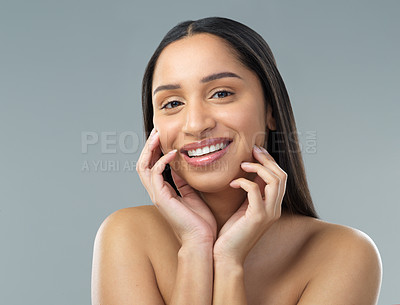 Buy stock photo Cropped shot of a beautiful young woman with flawless skin posing against a grey background