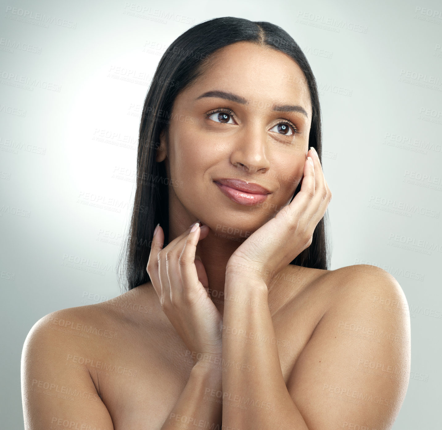 Buy stock photo Cropped shot of a beautiful young woman with flawless skin posing against a grey background