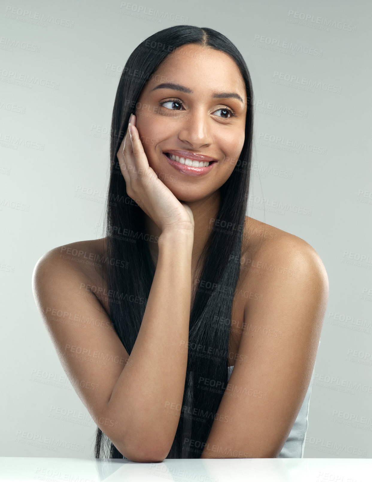 Buy stock photo Cropped shot of a beautiful young woman with flawless skin posing against a grey background