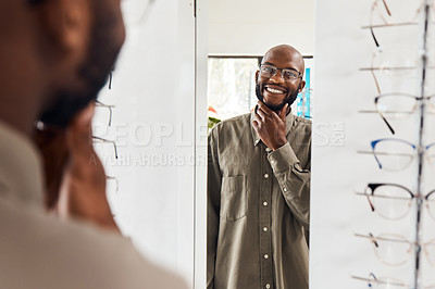 Buy stock photo Customer trying on glasses at an optometrist, smiling and looking confident with choice at optical store . Carefree man buying trendy spectacles to help with vision. Excited male satisfied with frame