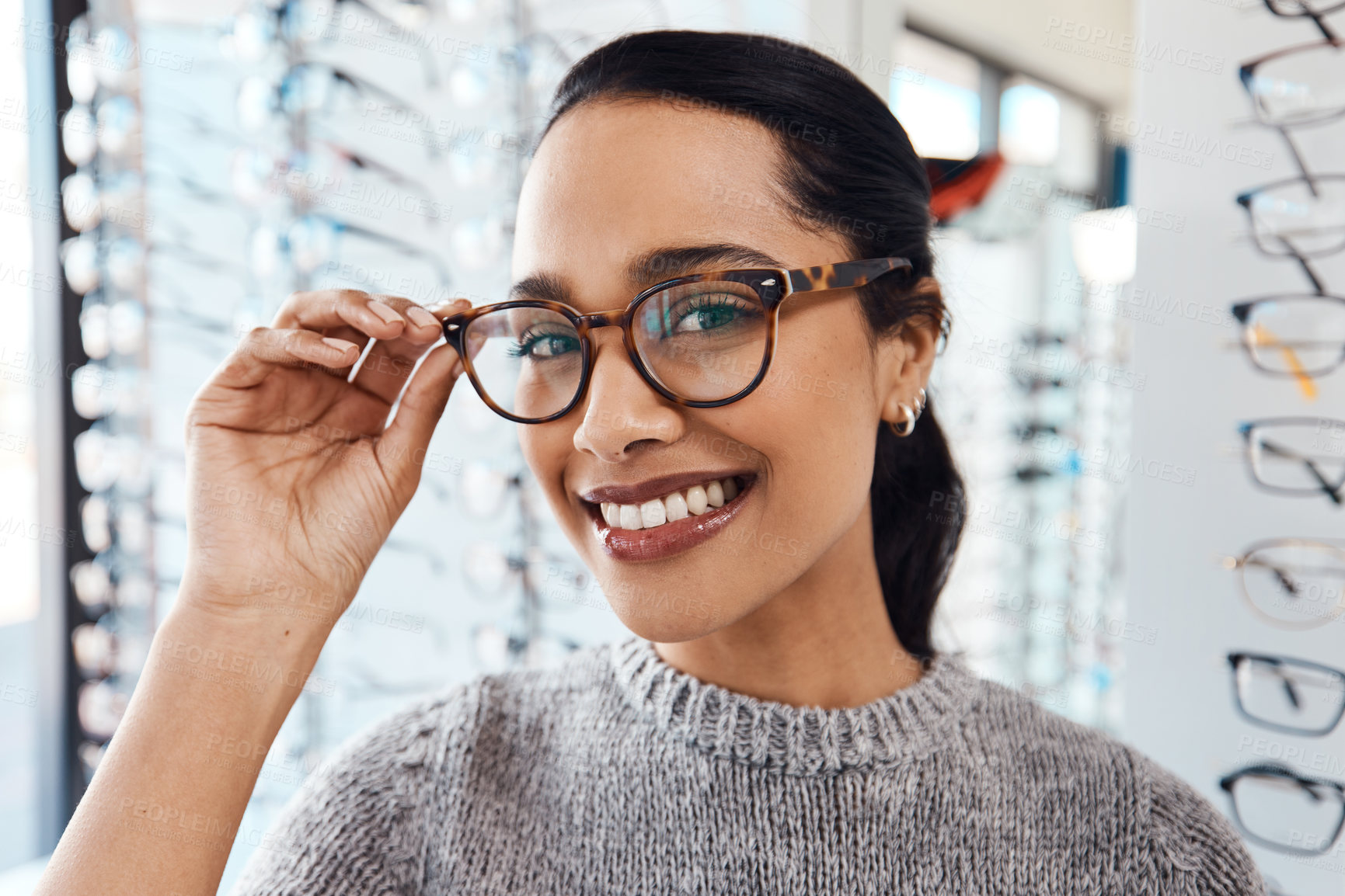 Buy stock photo Woman wearing pair of trendy glasses, stylish spectacles and new prescription lenses at an optometrist. Portrait of a customer choosing, buying and shopping for frames for better vision and eyesight
