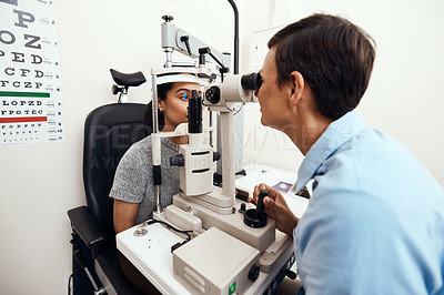 Buy stock photo Eye and vision test, exam or screening with an optometrist, optician or ophthalmologist and a patient using an ophthalmoscope. Testing and checking eyesight for prescription glasses or contact lenses