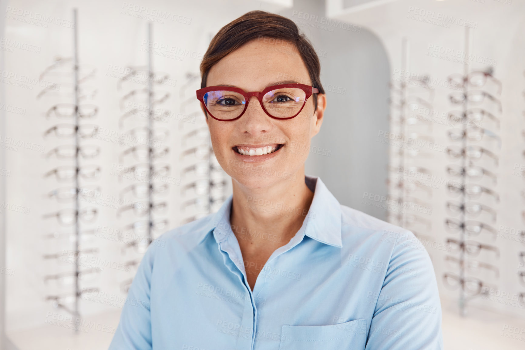 Buy stock photo Portrait of a confident young woman working in an optometrist’s office