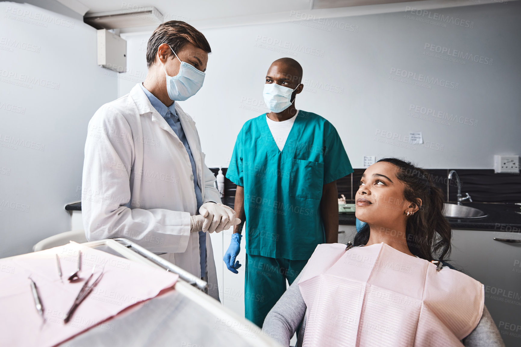 Buy stock photo Shot of a young woman having a consultation with her dentist