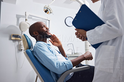 Buy stock photo Shot of a young man having a consultation with his dentist