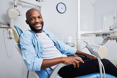 Buy stock photo Portrait of a young man having dental work done on his teeth