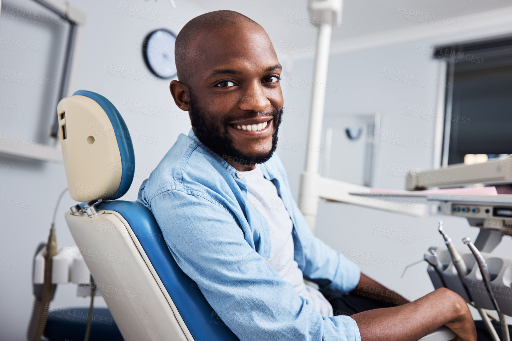 Buy stock photo Portrait of a young man having dental work done on his teeth