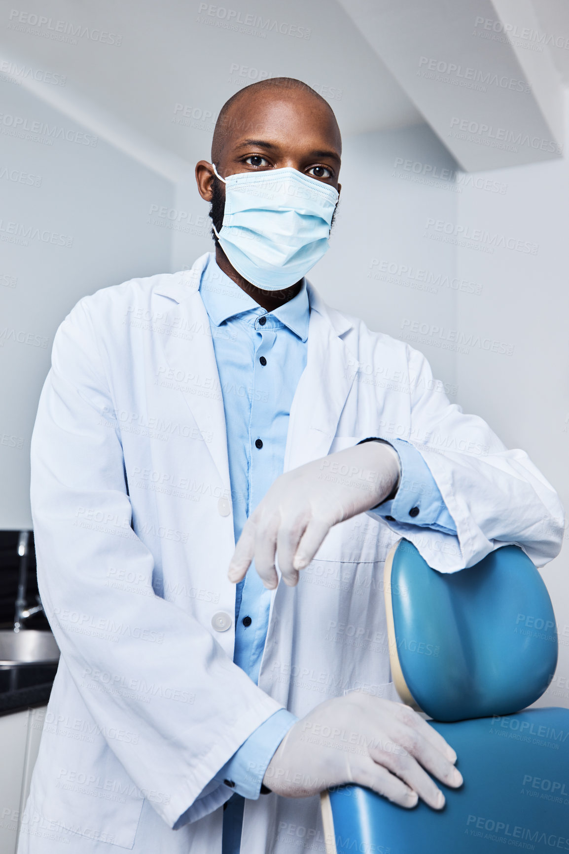 Buy stock photo Portrait of a masked young man working in a dentist’s office