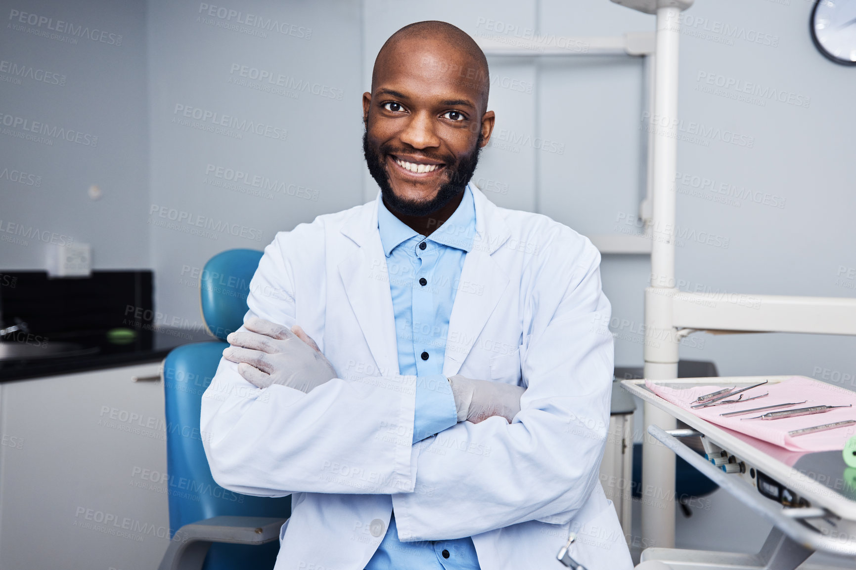 Buy stock photo Portrait of a confident young man working in a dentist’s office