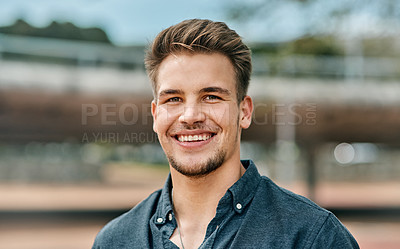 Buy stock photo Cropped portrait shot of a handsome young male student outside on campus