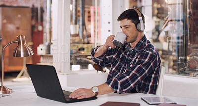 Buy stock photo Laptop, workshop and man with headphones, desk and construction office building. Typing, podcast and technology for work in architecture planning, workplace and internet for male entrepreneur  