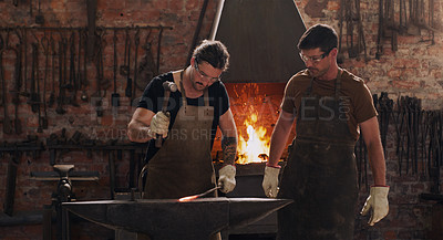 Buy stock photo Hammer, anvil and fire with men working in a forge for metal work manufacturing or production. Industry, welding and trade with blacksmith professionals in a workshop, plant or industrial foundry