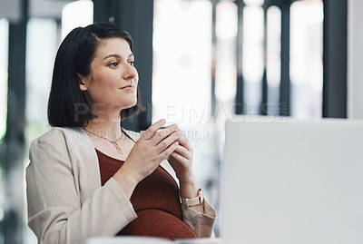 Buy stock photo Shot of a pregnant young businesswoman having coffee and using a laptop in a modern office
