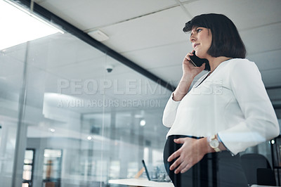 Buy stock photo Cropped shot of an attractive pregnant businesswoman standing alone in the office and feeling stressed while using her cellphone