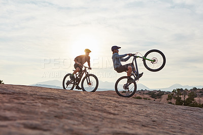 Buy stock photo Full length shot of two men out mountain biking together during the day