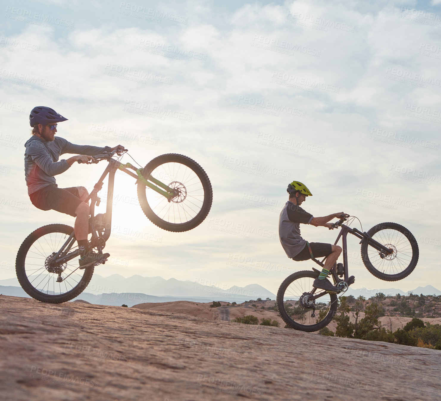 Buy stock photo Full length shot of two men out mountain biking together during the day