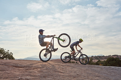 Buy stock photo Full length shot of two men out mountain biking together during the day