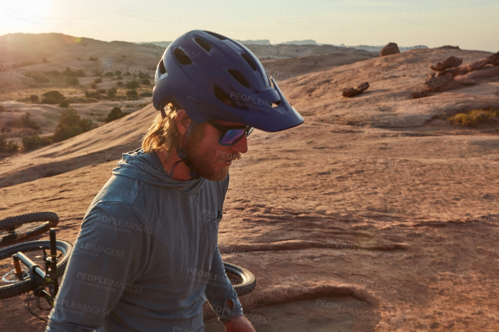 Buy stock photo Cropped shot of a young male athlete mountain biking in the wilderness