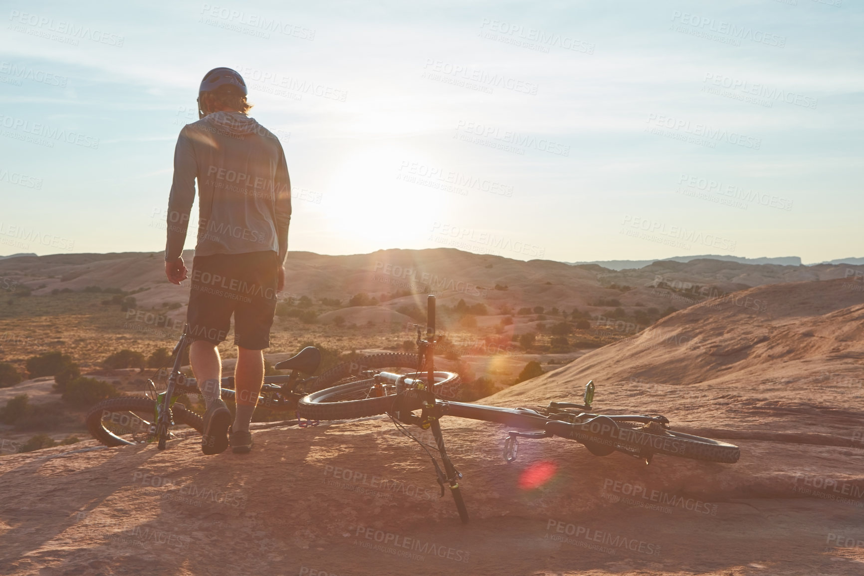 Buy stock photo Full length shot of a young male athlete mountain biking in the wilderness