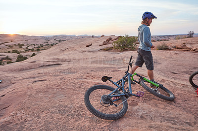 Buy stock photo Shot of a young man out mountain biking during the day