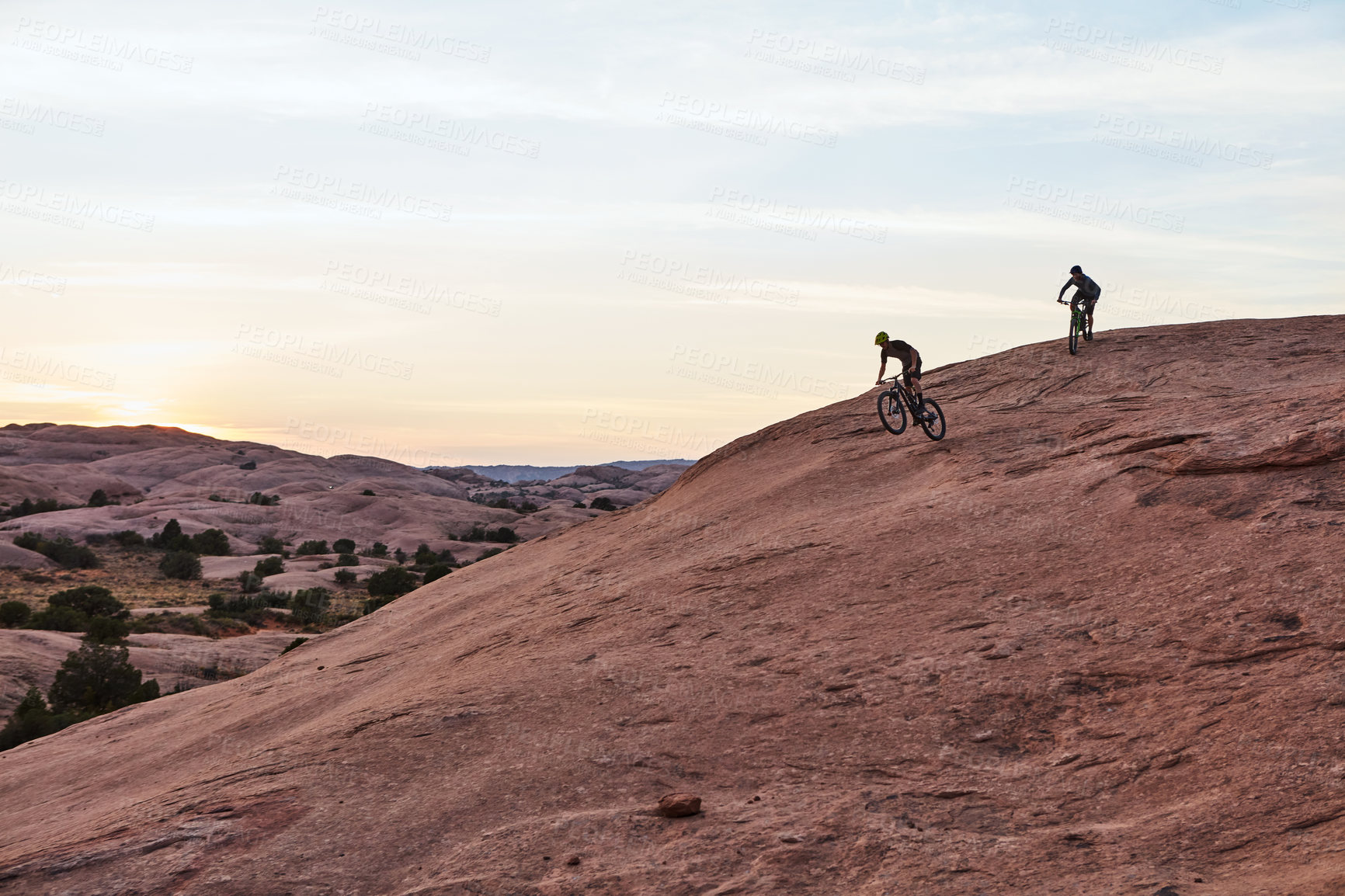 Buy stock photo Full length shot of two men out mountain biking together during the day