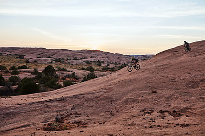 Buy stock photo Full length shot of two men out mountain biking together during the day