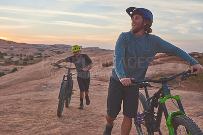 Buy stock photo Full length shot of two men out mountain biking together during the day