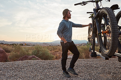 Buy stock photo Shot of a young man out mountain biking during the day