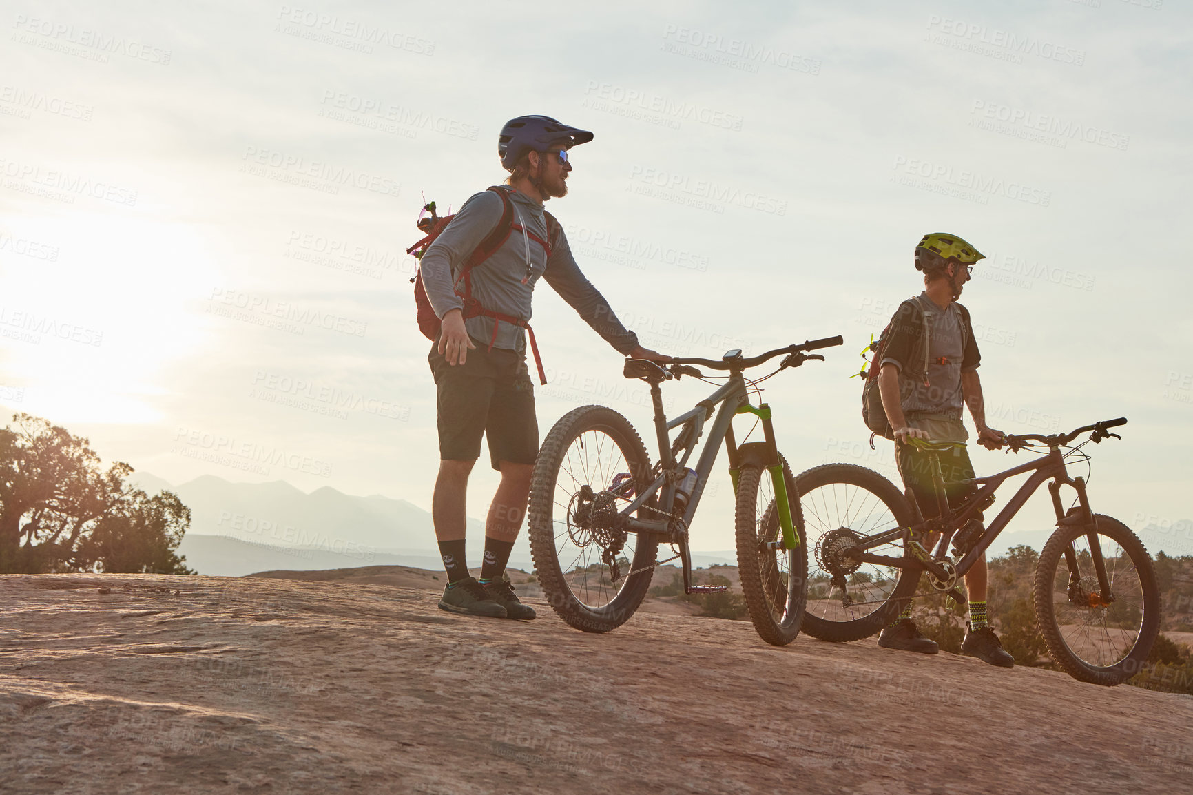 Buy stock photo Full length shot of two men out mountain biking together during the day