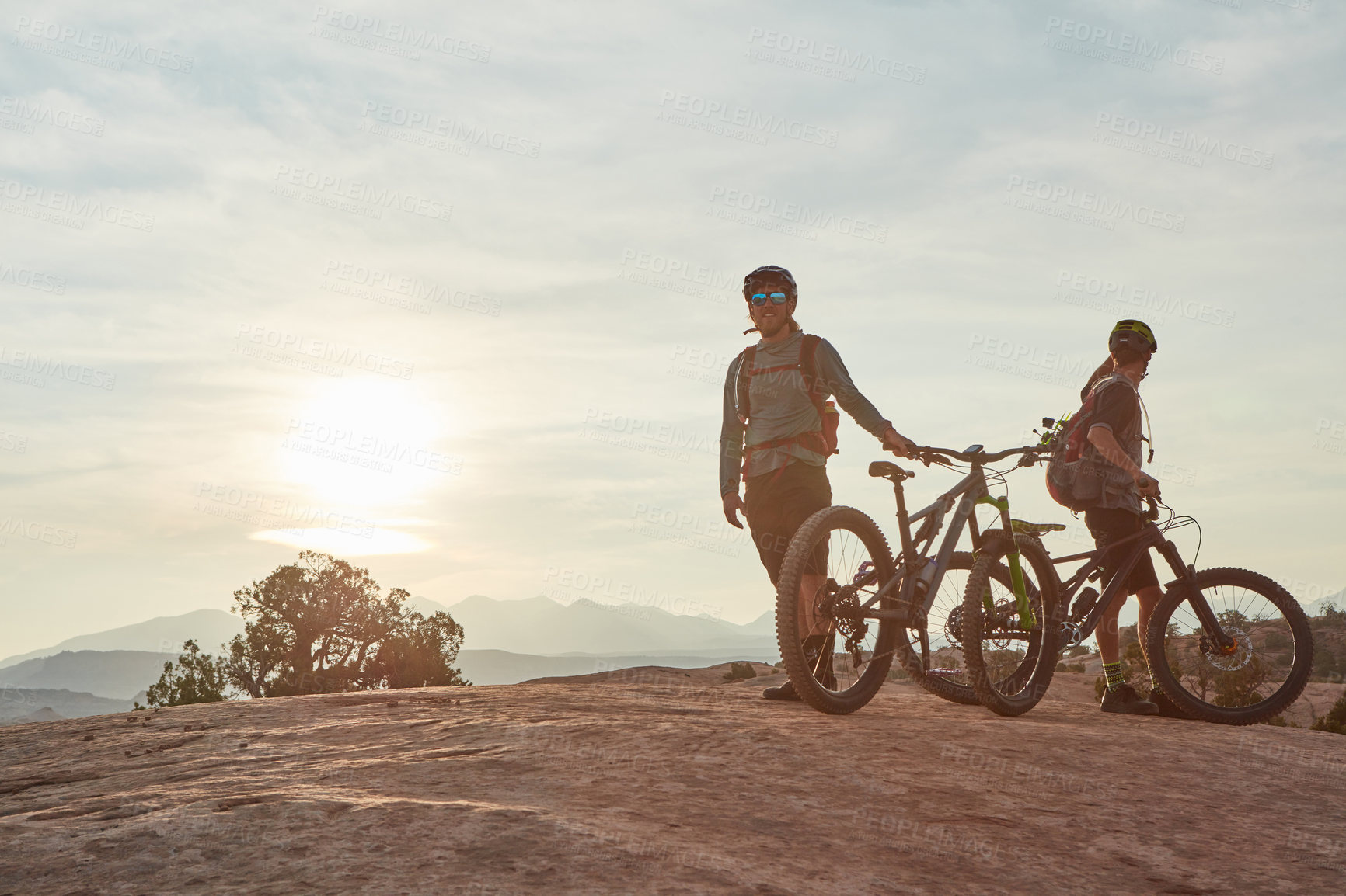 Buy stock photo Full length shot of two men out mountain biking together during the day