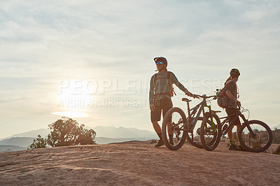 Buy stock photo Full length shot of two men out mountain biking together during the day