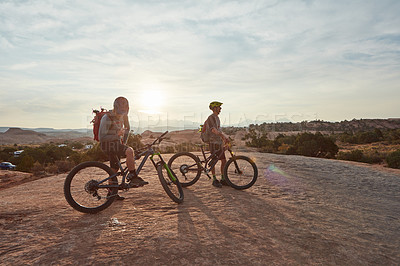 Buy stock photo Full length shot of two men out mountain biking together during the day