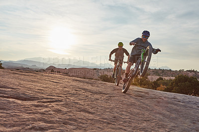 Buy stock photo Full length shot of two men out mountain biking together during the day