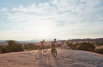 Buy stock photo Full length shot of two men out mountain biking together during the day