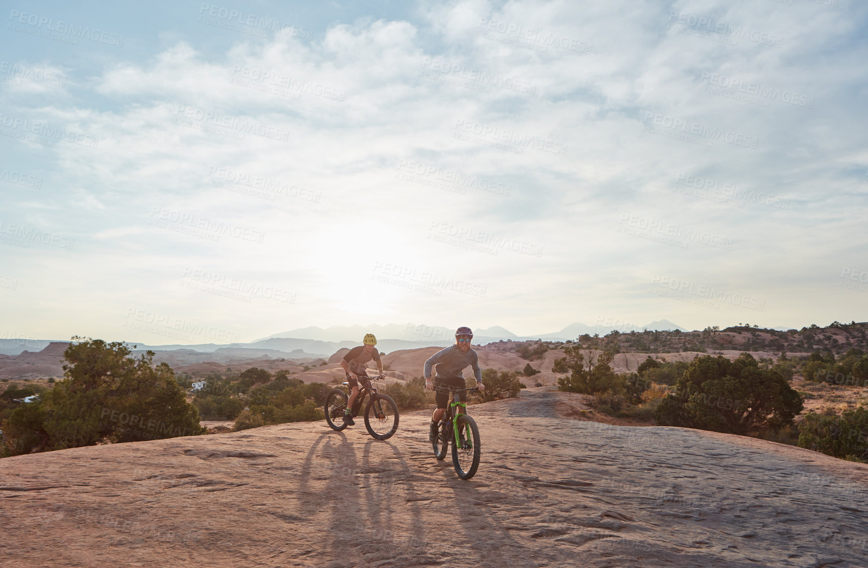 Buy stock photo Full length shot of two men out mountain biking together during the day