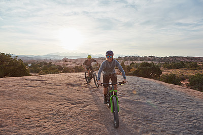 Buy stock photo Shot of a young man out mountain biking during the day