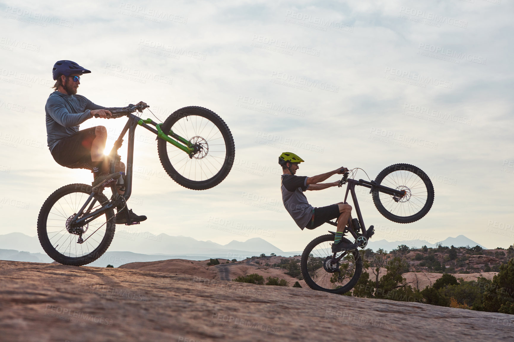 Buy stock photo Full length shot of two men out mountain biking together during the day