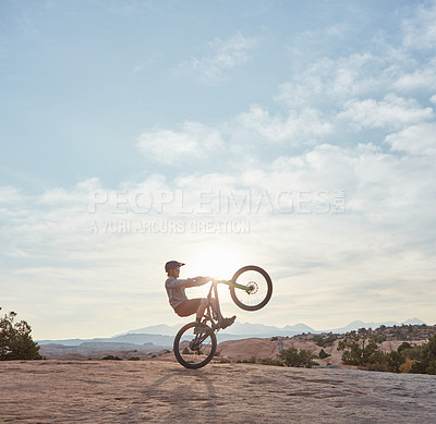 Buy stock photo Shot of a young man out mountain biking during the day