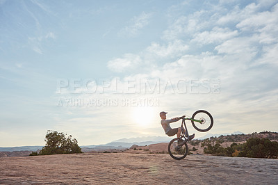 Buy stock photo Shot of a young man out mountain biking during the day