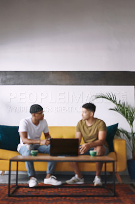 Buy stock photo Shot of two young men sitting together in a coffee shop