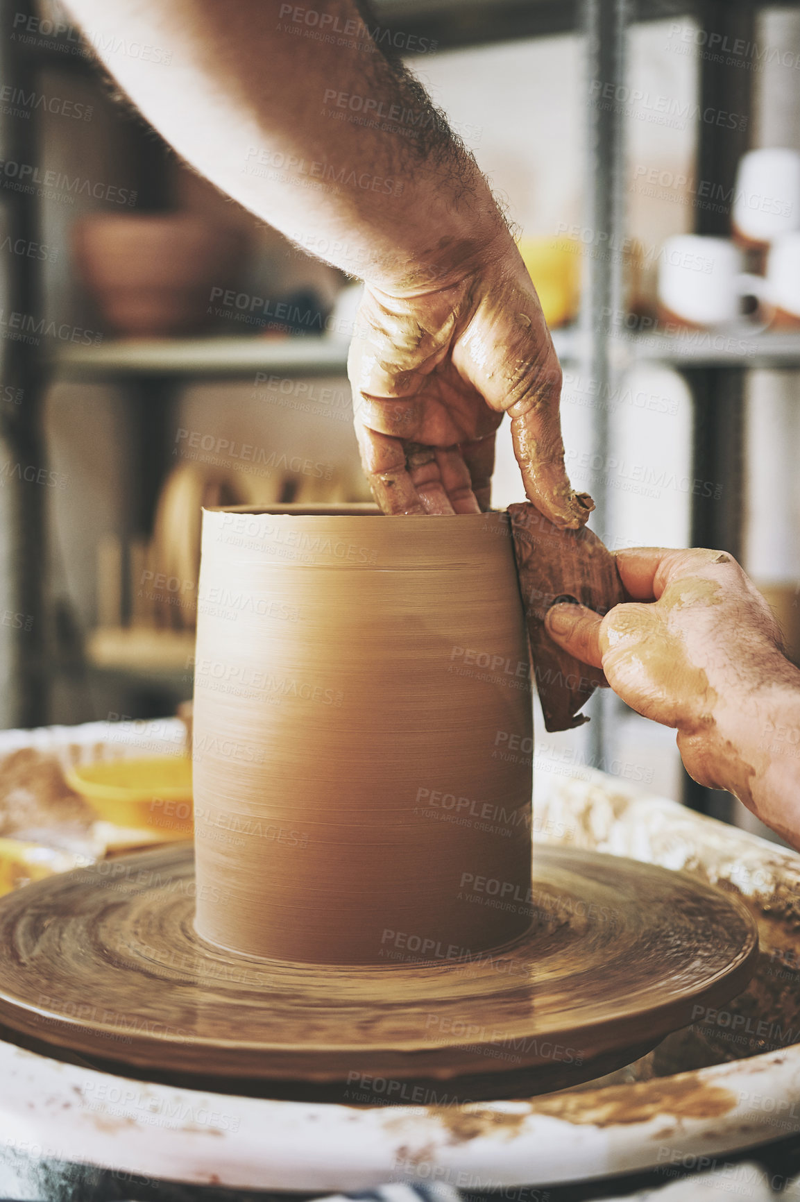 Buy stock photo Shot of an unrecognisable man working with clay in a pottery studio