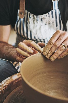 Buy stock photo Shot of an unrecognisable man working with clay in a pottery studio