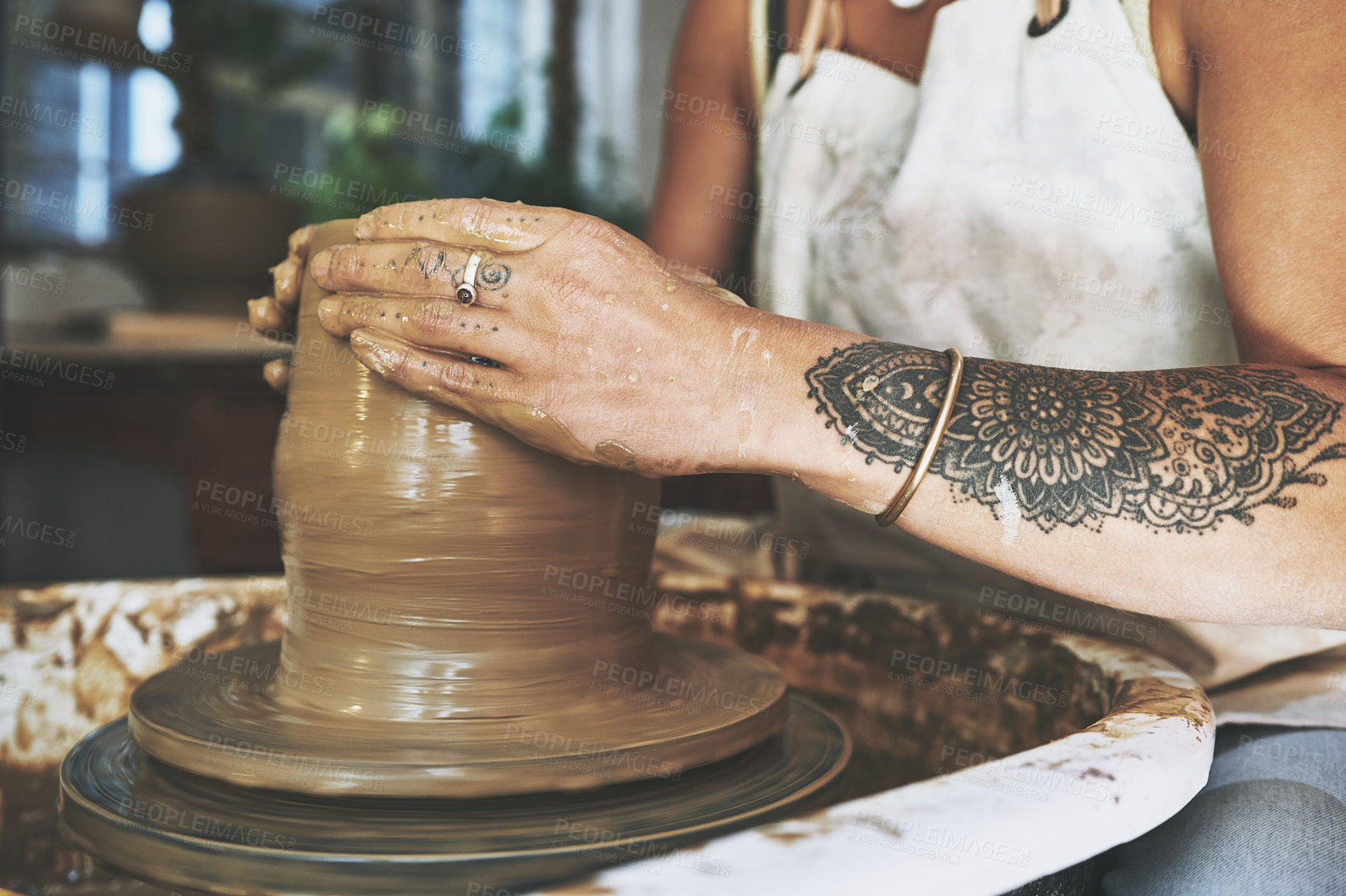 Buy stock photo Shot of an unrecognisable woman working with clay in a pottery studio